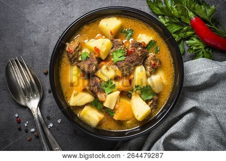 Goulash With Meat And Vegetables On Black Background. Beef Stew With Vegetables. European Cuisine. T