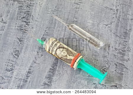 No To Drugs. White Glass Ampoule And Syringe With Needle And Money. Black Concrete Background.