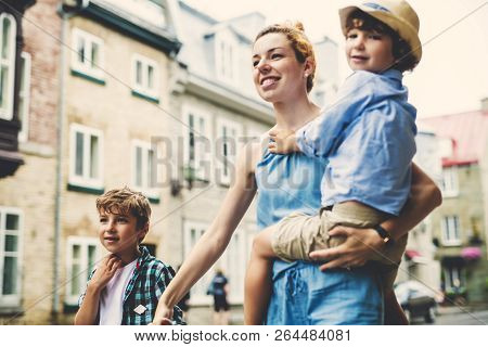 Mother With Her Two Son Outside In An Urban Street