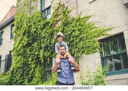 Dad With Her Son Outside In A Urban Street