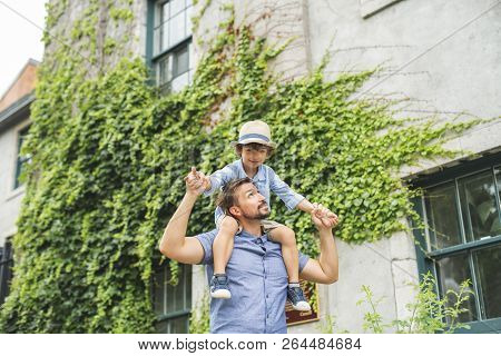 Dad With Her Son Outside In A Urban Street