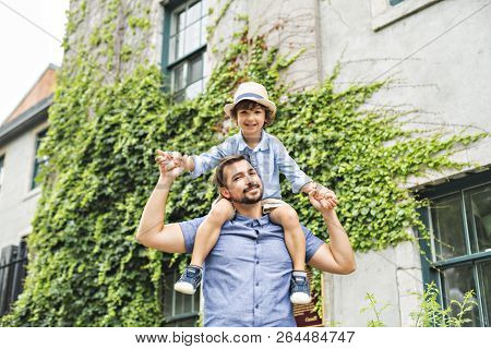 Dad With Her Son Outside In A Urban Street