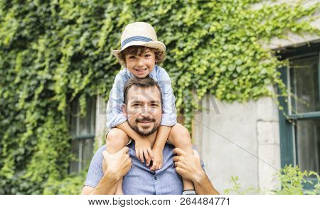 Dad With Her Son Outside In A Urban Street