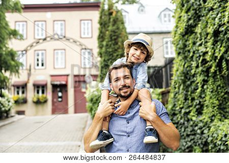 Dad With Her Son Outside In A Urban Street