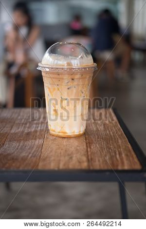 Iced Caramel Coffee In Plastic Glass (close Up)