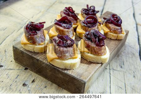 Croutons Of Bread With Cheese Sausage And Caramelized Onion