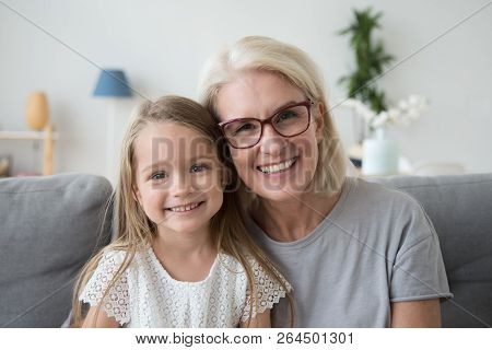 Portrait Of Smiling Grandma And Granddaughter Spending Time Toge