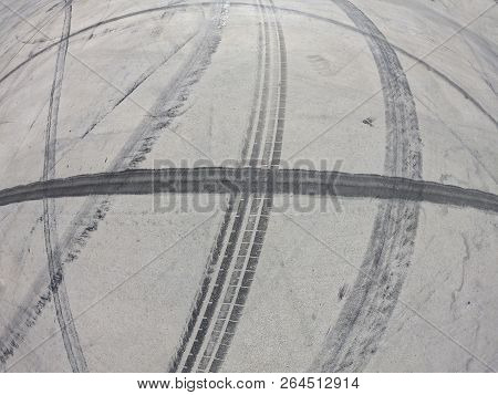 Wheel Marks On Concrete And On The Pavement After Drifting On A Sunny Day