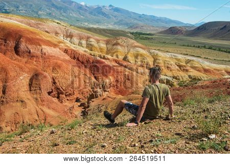 Relaxing man in Valley of Mars landscapes in the Altai Mountains, Kyzyl Chin, Siberia, Russia