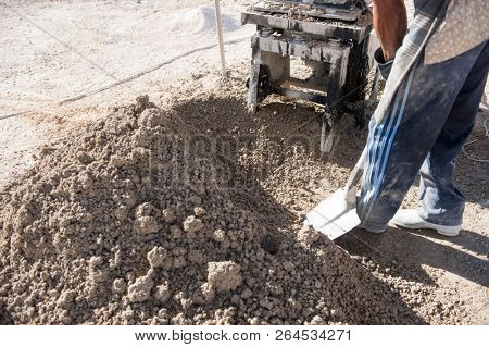 mMan making brick from concrete mix