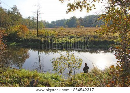 Fisherman Standing On Riverside And Trying To Catch Fish. Male Hobby. Recreation