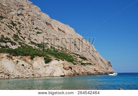 MAJORCA, SPAIN - SEPTEMBER 30, 2018: People swim in the Cala de Boquer on the Spanish island of Majorca. The cove lies at the end of the Boquer valley walk through the Tramuntana mountains.