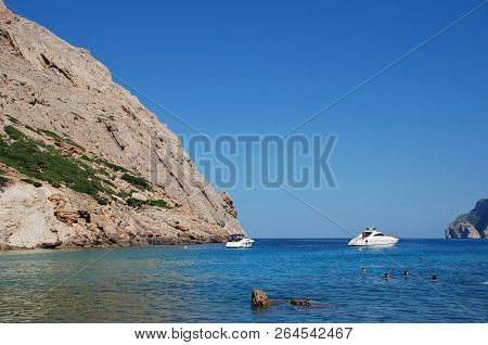 MAJORCA, SPAIN - SEPTEMBER 30, 2018: People swim in the Cala de Boquer on the Spanish island of Majorca. The cove lies at the end of the Boquer valley walk through the Tramuntana mountains.