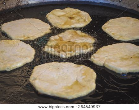 Romanian Traditional Pies Are Fried In A Large Frying Pan