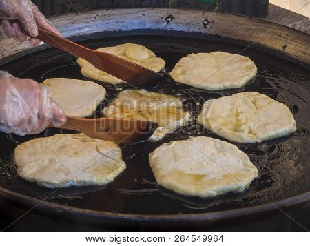 Romanian Traditional Pies Are Fried In A Large Frying Pan