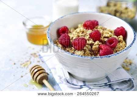 Homemade Multicereal Granola With Fresh Raspberry, Honey And Dairy Product.
