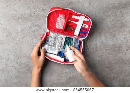 Woman With First Aid Kit On Gray Background, Top View
