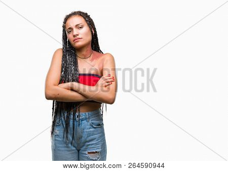 Young braided hair african american with pigmentation blemish birth mark over isolated background skeptic and nervous, disapproving expression on face with crossed arms. Negative person.