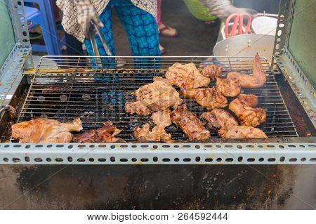 Street Food Vendor Cooking Barbecue Meat On A Rack. Vietnam