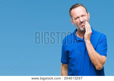 Middle age hoary senior man over isolated background touching mouth with hand with painful expression because of toothache or dental illness on teeth. Dentist concept.