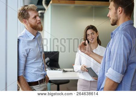 Group Of Young Modern People In Smart Casual Wear Having A Brainstorm Meeting While Standing In The 