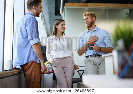 Group Of Young Modern People In Smart Casual Wear Having A Brainstorm Meeting While Standing In The 