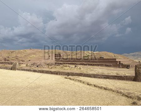 Stormy Clouds Over Hills In Bolivia Ancient Ruins With Grass