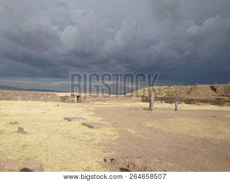 Stormy Clouds Over Hills In Bolivia Ancient Ruins With Grass