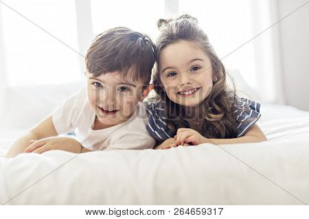 Brother And Sister Having Fun Together On Bed