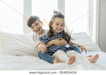 Brother And Sister Having Fun Together On Bed