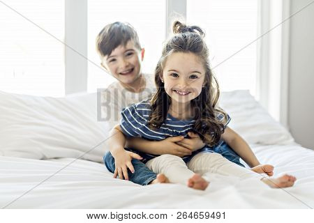Brother And Sister Having Fun Together On Bed