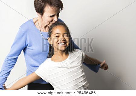 Black Girl Child With Grandmother In Studio White Background
