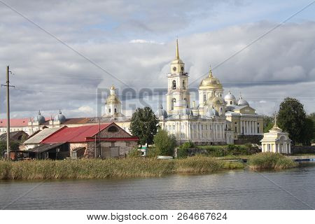 Orthodox Chirch And Church Buildings Near The Lake, Nilov Monastery Seen From Water In Russia, Selig