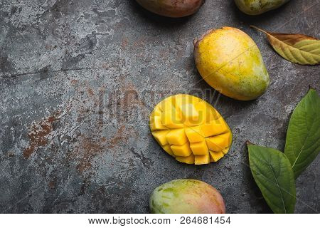 Fresh Mango Tropical Fruits Over Gray Background, Top View With Copy Space.