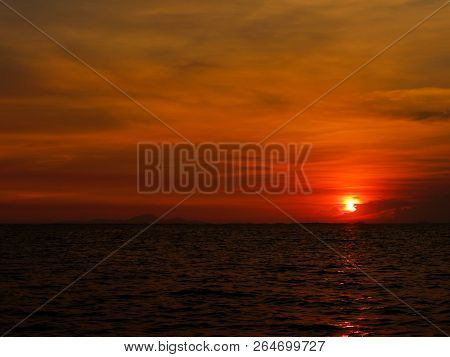 Sunset Last On Horizontal In Right Frame Over Orange Sky And Ocean