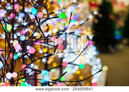 Close Up Colorful Bulb Lights On Tree Shape Garland On The Background Of Various Glowing Christmas L