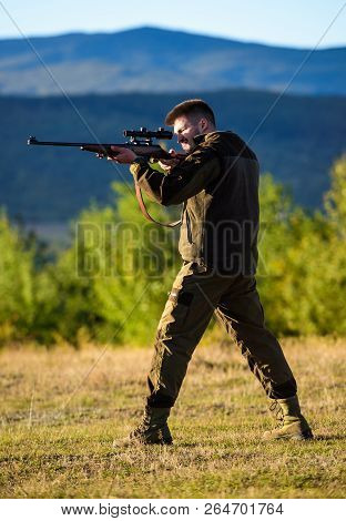 Man Rifle For Hunt. Hunter Khaki Clothes Ready To Hunt Hold Gun Mountains Background. Hunter With Ri