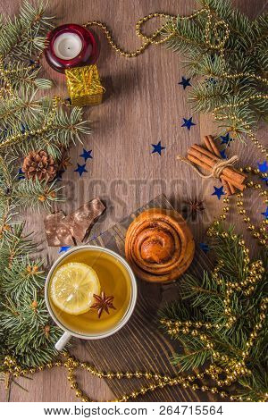 Delicious Fragrant Tea With Warm Pastries With Cinnamon On A Wooden Background With Christmas Tree B