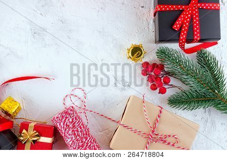 Christmas Decorative Background With Fir Branches, Cones, Redr And Black Christmas  Gifts, Ball On T