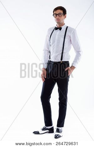 Full Body Shot Of Young Handsome Man Standing While Wearing Susp
