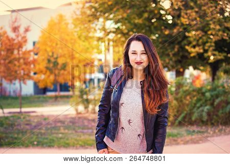 Lifestyle Portrait Of Stundent Girl In The College Campus, Sunny Autumn Day.