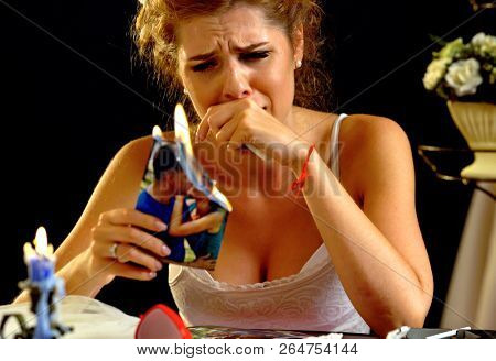Burning photography kissing newlywed. Broken heart woman. Couple break up. Sad bride on unhappy wedding. Woman and groom quarrel. Girl burns in fire candle family pictures. Portrait crying female.