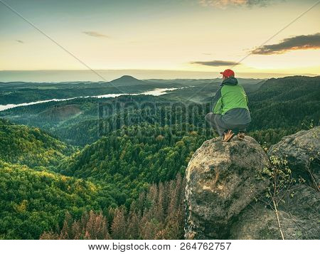 Man Walking On The Edge Of A Cliff At Summit. Hrensko Range.  Climber Enjoying Beautiful Nature View