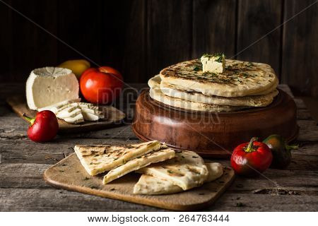 Pita Bread On Wooden Board With Feta Cheese And Tomatoes And Pepper. Still Life Of Food. Georgian Cu