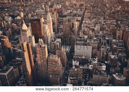 New York City rooftop view with downtown Manhattan skyscrapers and urban cityscape.