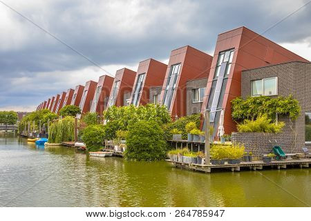 Ecological Houses With Integrated Solar Panels And Hanging Gardens On Waterfront In Urban Area Of Th