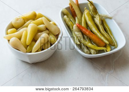 Pickled Green Pepper Pickles In Bowls. Traditional Organic Food.