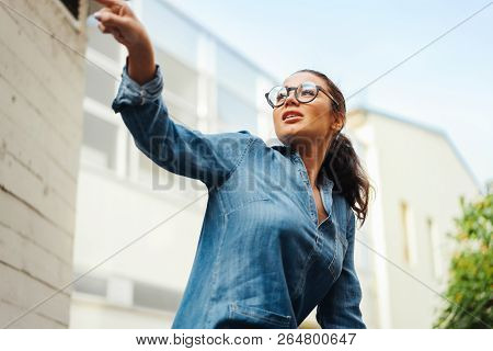 Close Up Of Young Attractive Bespectacled Woman Looking Aside.
