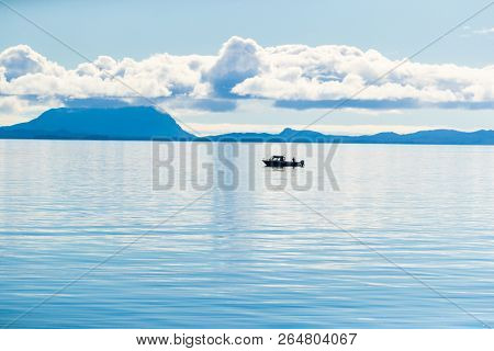 Alaska scenery tranquil scene in the morning - fisherman boat on Arctic sea in Ketchikan, USA travel in summer.