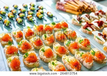 Cold Snacks With Cheese And Fish On The Table